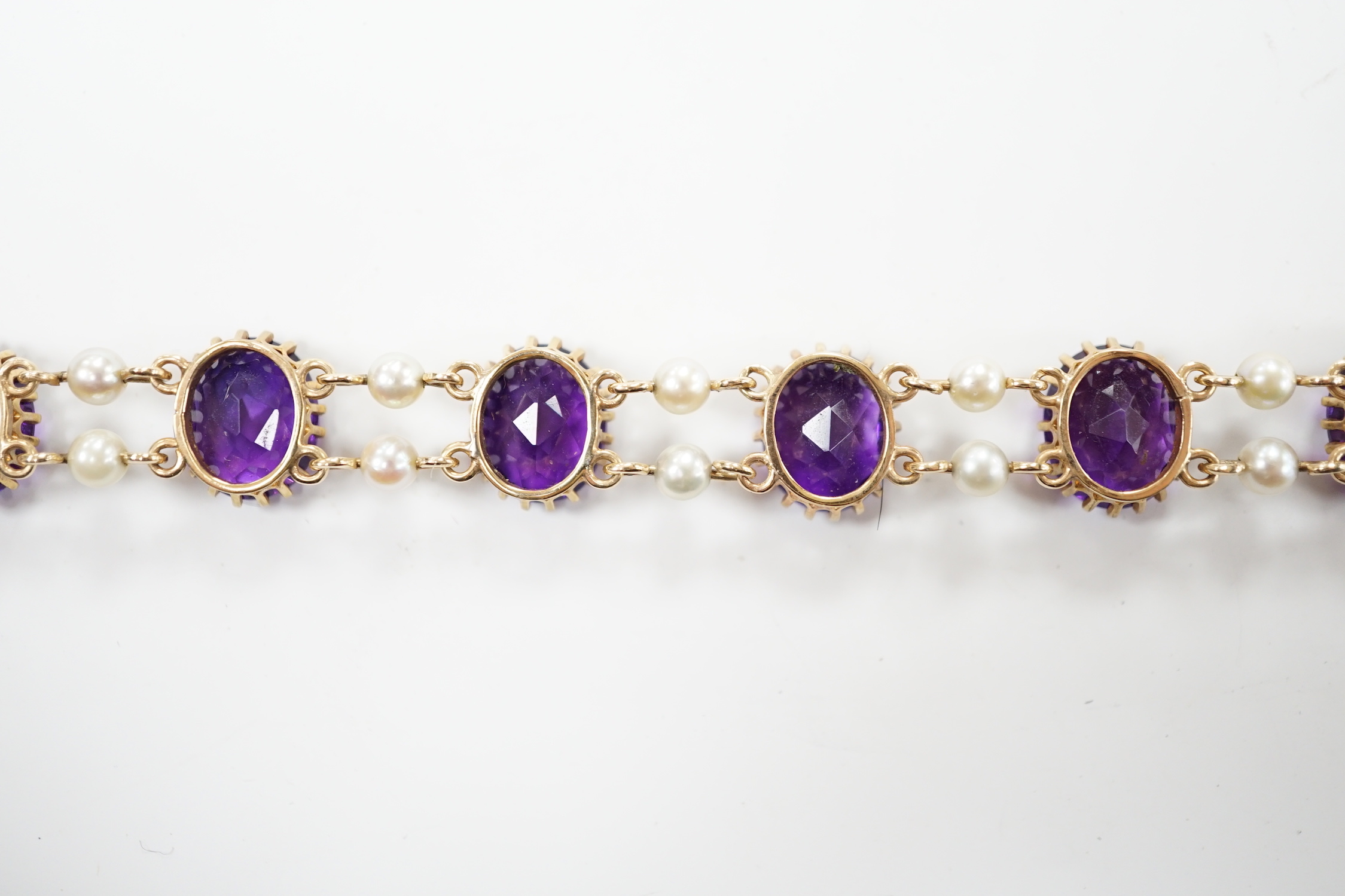 A 1970's Edwardian style 9ct gold amethyst and cultured pearl cluster set bracelet, 17.5cm, gross weight 15.9 grams.